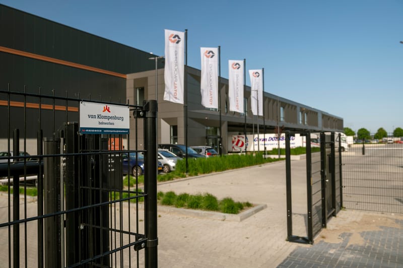 Draaipoort in het hekwerk bij de inrit van een productie- en logistiekpand